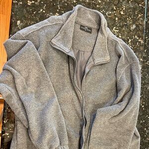 Men’s size medium gray fleece jacket. The back is decorated with Alaskan design.